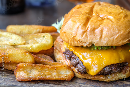 burger and french fries on the wooden table, cheeseburger