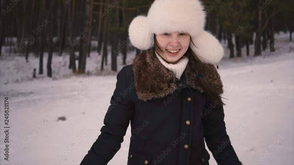 Blowing Snow, Beautiful Female Model having fun near forest. Young woman enjoying snow. Winter forest Blowing Snow, Beautiful Female Model having fun near forest. Young woman enjoying snow. Winter forest