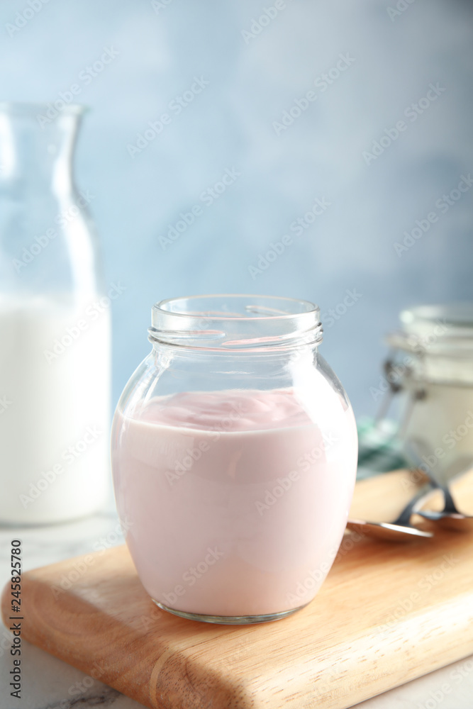 Glass jar of fresh yogurt on table. Space for text Glass jar of fresh yogurt on table. Space for text