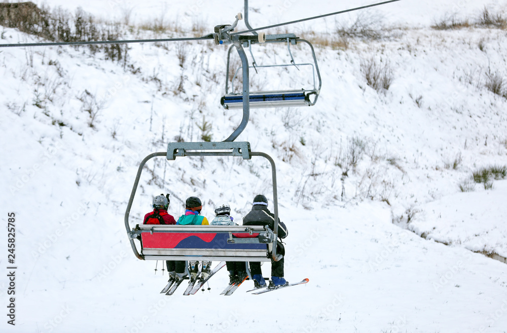Chairlift with people at ski resort. Winter vacation Chairlift with people at ski resort. Winter vacation