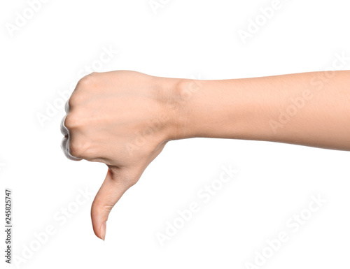 Woman showing thumb down sign on white background, closeup. Body language