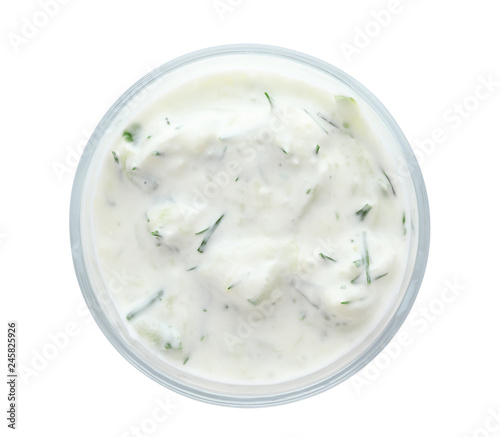 Bowl with cucumber sauce on white background, top view