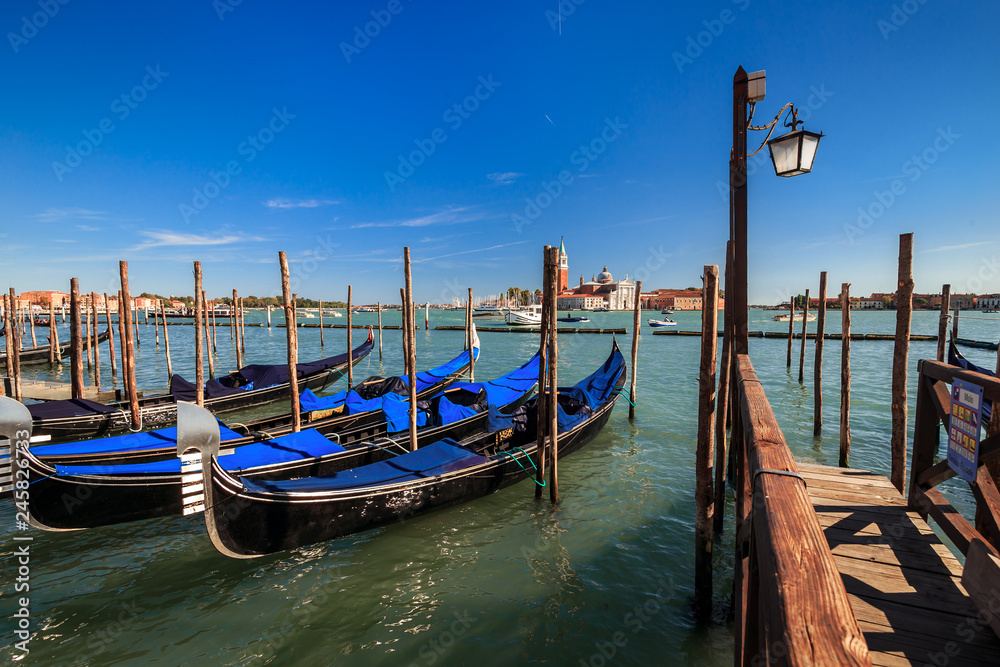 View of San Giorgio Maggiore island and Cathedral of the same name from the pier with gondolas on the waterfront near Saint Mark's square. Venice, Italy.