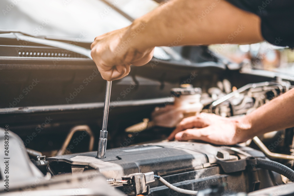 Auto mechanic working in garage Technician Hands of car mechanic working in auto repair Service and Maintenance car check. Auto mechanic working in garage Technician Hands of car mechanic working in auto repair Service and Maintenance car check.