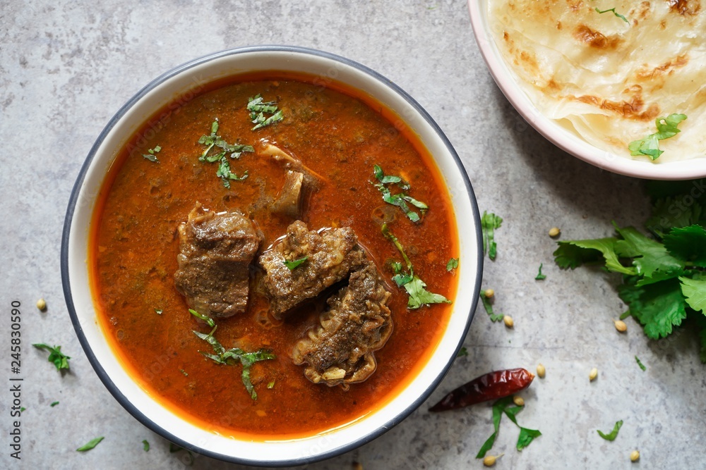 Lamb Mutton goat curry served with Paratha, overhead view - obrazy, fototapety, plakaty 