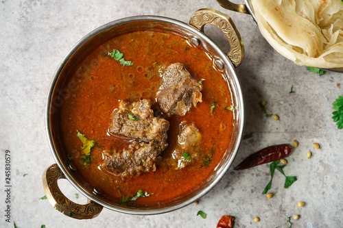 Lamb Mutton goat curry served with Paratha, overhead view