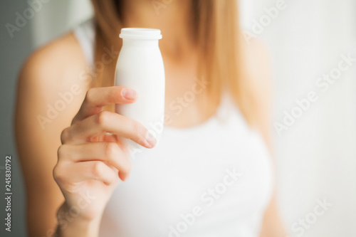 Woman Holding Drinking Yoghurt Indoors. Healthy Nutrition