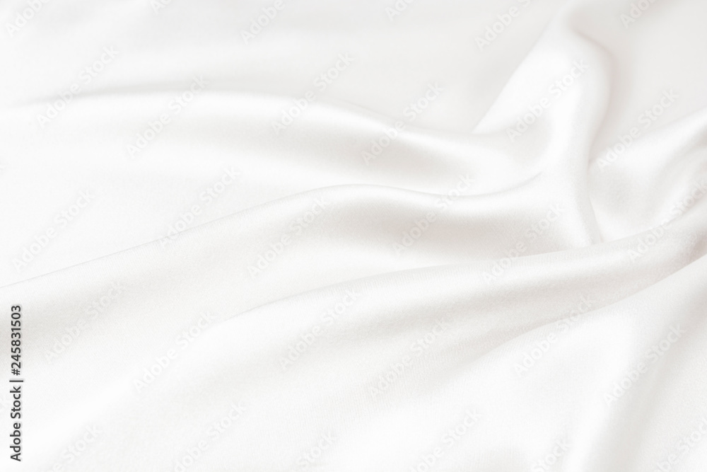 The texture of the satin fabric of white color for the background The texture of the satin fabric of white color for the background