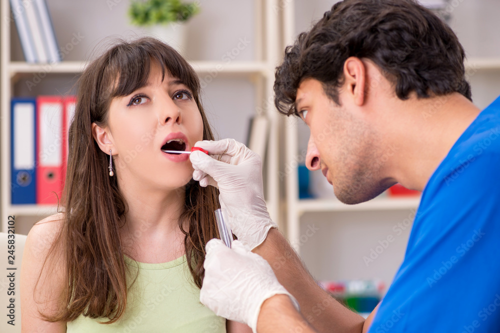 Doctor getting saliva test sample in clinic hospital Doctor getting saliva test sample in clinic hospital