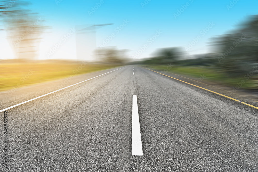 Empty asphalt road and speed motion blur on highway at countryside