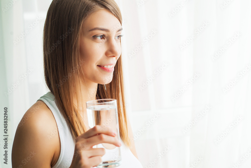 Healthy Lifestyle. Close-up Portrait Of Young Woman Drinking Refreshing Pure Water From Glass. Healthcare. Drinks. Water. Health, Beauty, Diet Concept Healthy Lifestyle. Close-up Portrait Of Young Woman Drinking Refreshing Pure Water From Glass. Healthcare. Drinks. Water. Health, Beauty, Diet Concept