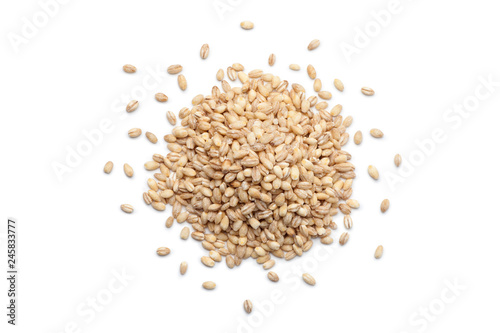 Leinwand Poster Pile of peeled barley isolated on white background. Top view.