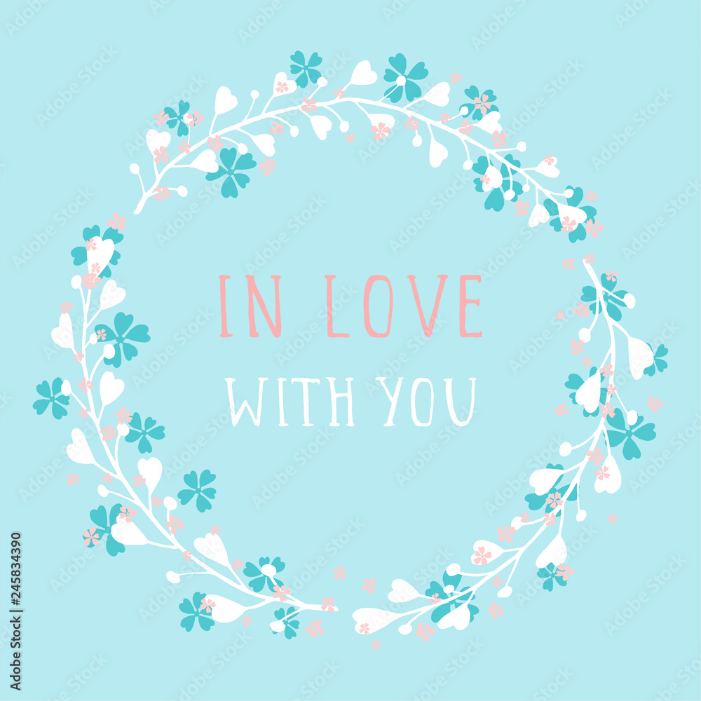 Vector hand drawn illustration of text IN LOVE WITH YOU and floral round frame on blue background. Colorful.