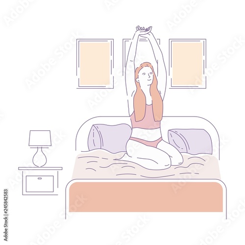 Woman stretching on bed morning waking up routine