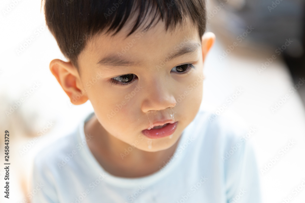 Close up mucus flowing from nose, Asian boy has a runny nose with clear snot. Close up mucus flowing from nose, Asian boy has a runny nose with clear snot.