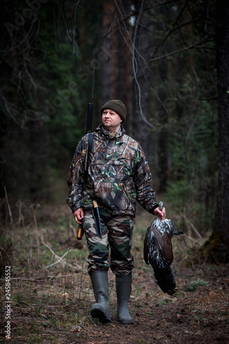 grouse hunter returns from the forest with prey