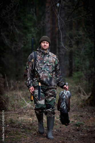 grouse hunter returns from the forest with prey