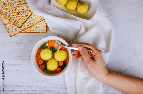 Traditional Jewish passover dish matzah ball soup served with matzah a Passover Haggadah photo