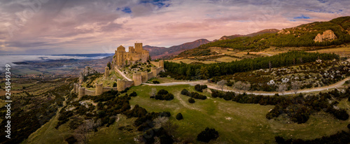 Aerial panorama view of medieval Romanesque partially restored Loarre castle near Huesca in Aragon province Spain surrounded by fog and clouds