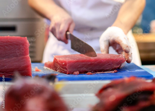 Bilde på lerret Chef cutting fresh tuna fish in the kitchen