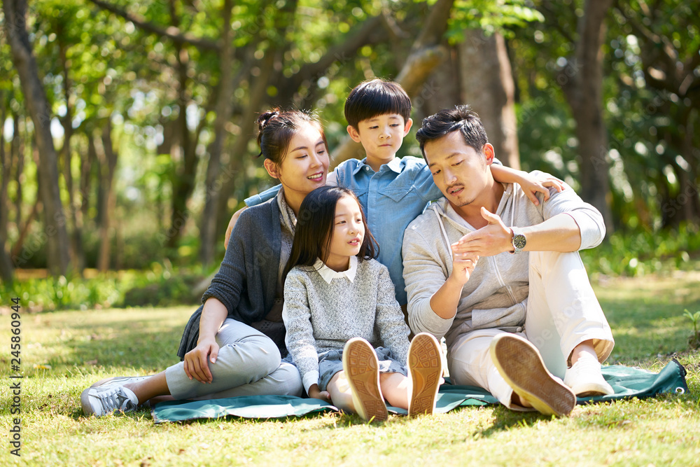 asian family with two children chatting park asian family with two children chatting park
