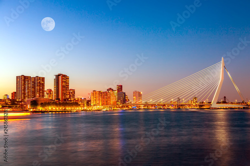 Erasmus bridge over the river Meuse with skyscrapers and moon in Rotterdam, South Holland, Netherlands during twilight sunset. Rotterdam panorama
