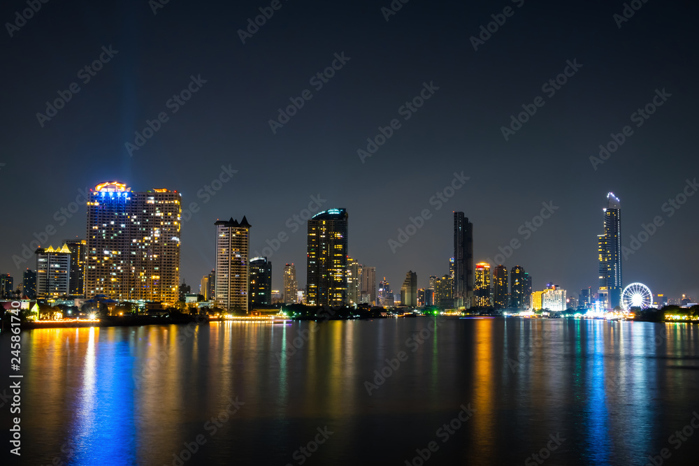 Landscape and Cityscape. Building along the Chao Phraya River at night. at Asiatique The Riverfront The landmark of Bangkok Thailand.