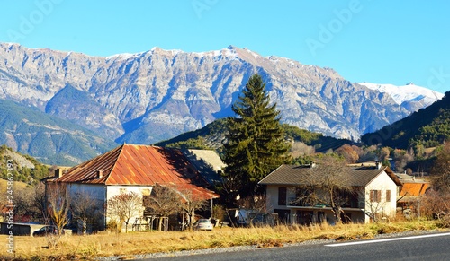 A small village near the road in french Alps near lac de serre-poncon on a sunny day. Ecrins massif photo