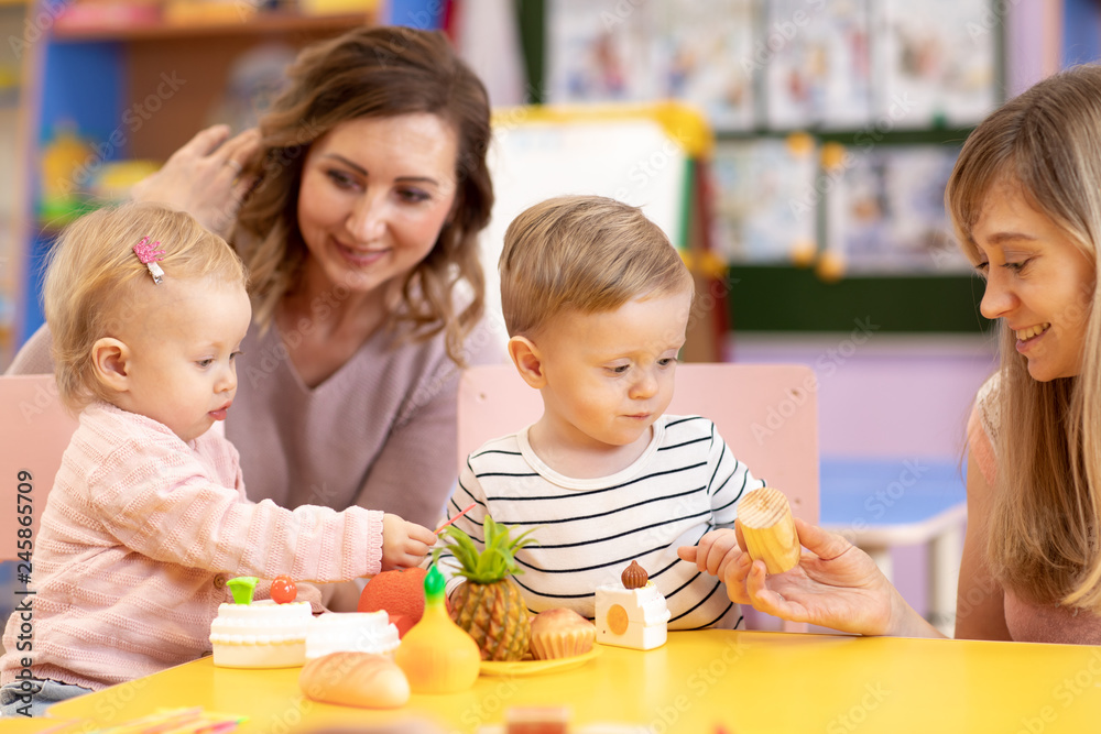 Babies playing with toys in montessori school Babies playing with toys in montessori school