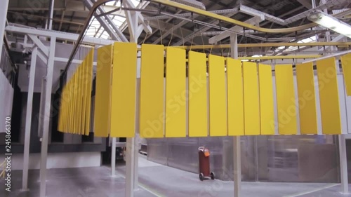 Powder coating line. Flat metal panels move on an overhead conveyor. photo