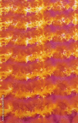 Obraz na płótnie Photograph of a handpainted tie-dye fabric background with bright irregular spors pattern