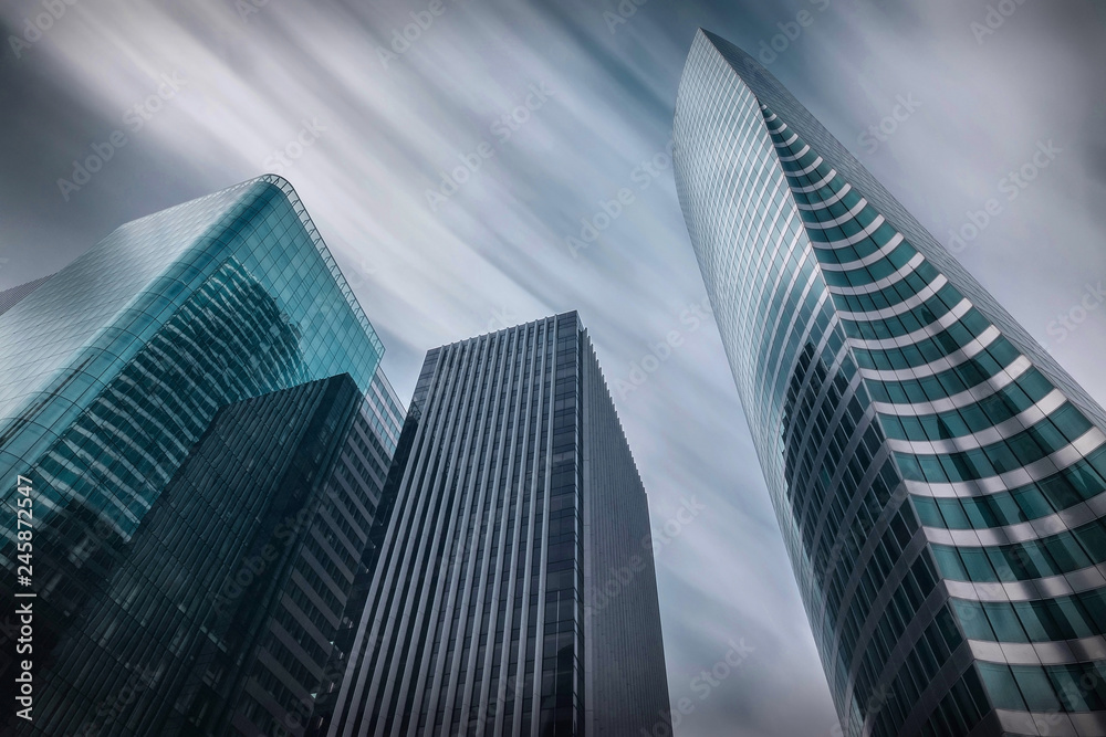 Fototapeta premium New modern business buildings under sky with clouds in Paris. 