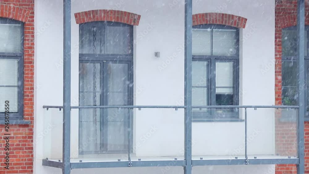 Video view of the balcony in the loft apartment from the street during heavy snow Video view of the balcony in the loft apartment from the street during heavy snow