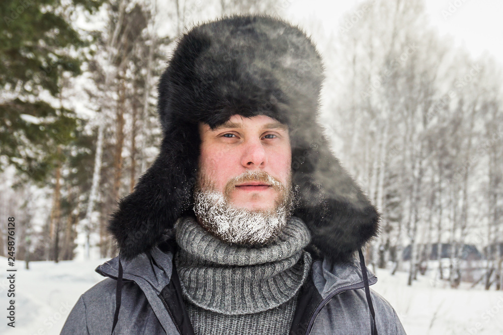 frozen man with a beard in winter in a forest with snowdrifts fell ill from the cold after a walk in the village frozen man with a beard in winter in a forest with snowdrifts fell ill from the cold after a walk in the village