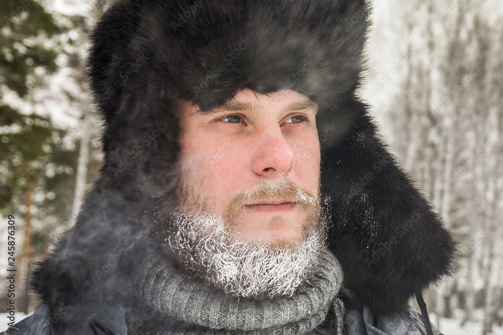 frozen man with a beard in winter in a forest with snowdrifts fell ill from the cold after a walk in the village frozen man with a beard in winter in a forest with snowdrifts fell ill from the cold after a walk in the village