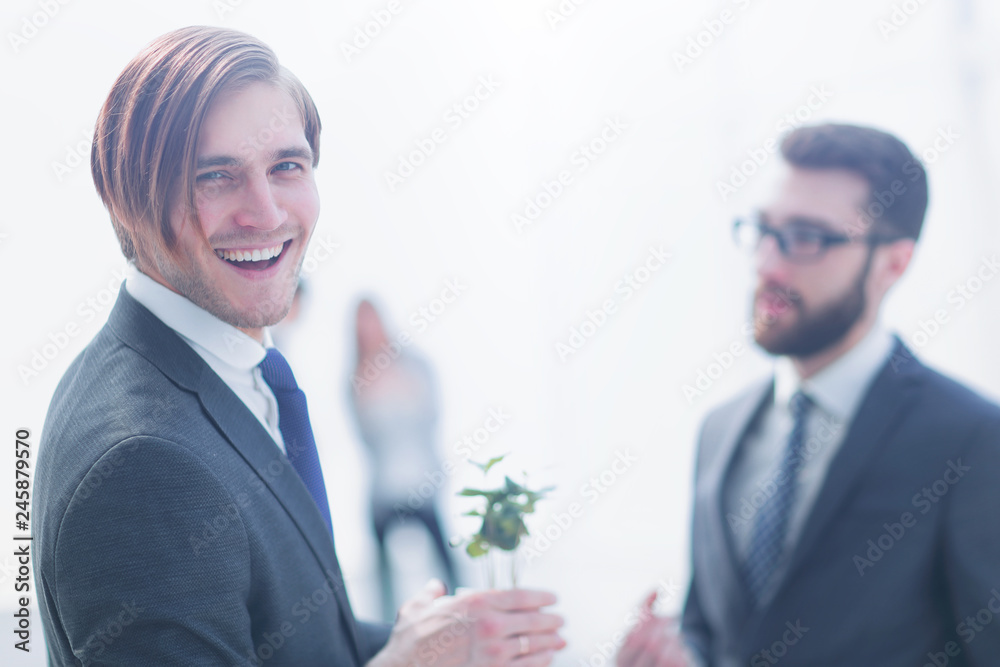 young businessman with green young sprout young businessman with green young sprout