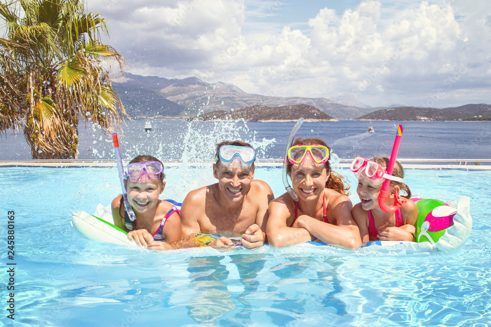 Portrait of big family swimming in pool on sea resort