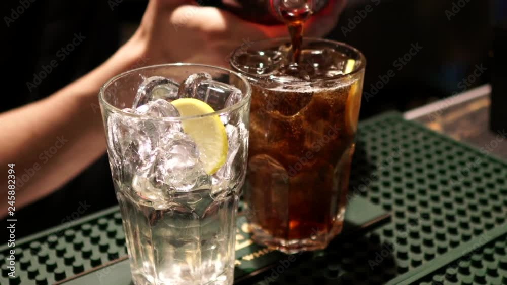 The bartender prepares a cocktail with Cola