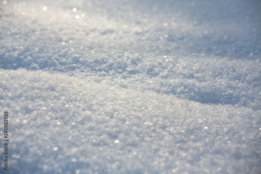 Snow texture background with copy space. Snowflakes sparkle in the sun in the cold, bokeh, blur. Shot at wide open aperture. White snowflake background Snow texture background with copy space. Snowflakes sparkle in the sun in the cold, bokeh, blur. Shot at wide open aperture. White snowflake background