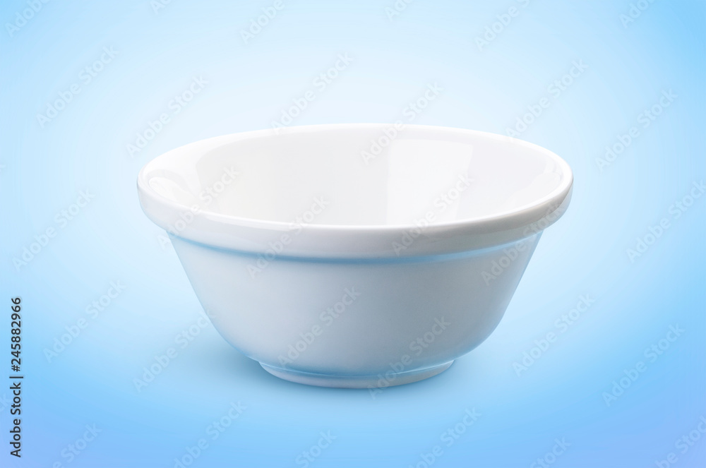 Empty white bowl isolated on blue background, ideal for the presentation of dairy products