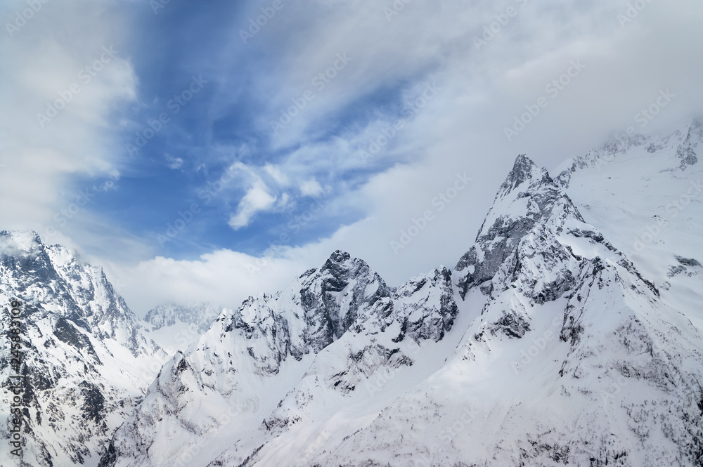 Gray high mountain peaks covered with ice Gray high mountain peaks covered with ice