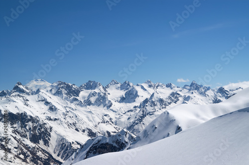 Snow covered mountains and snowy off-piste slope for freeriding