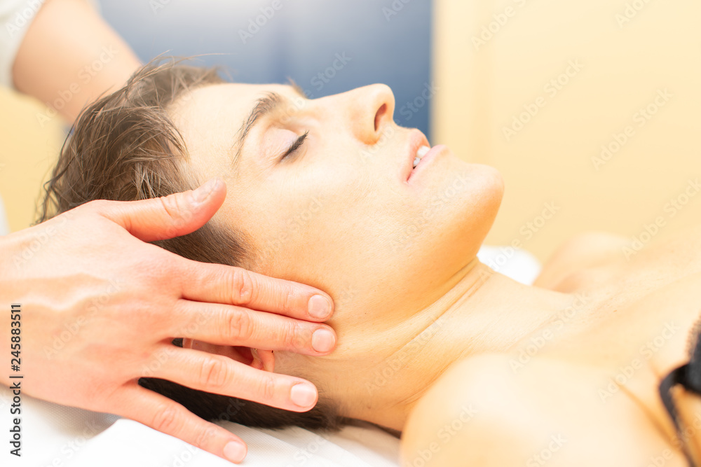 Beautician practices a relaxing beauty massage to a young woman Beautician practices a relaxing beauty massage to a young woman