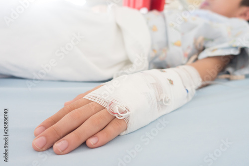Little boy get sick from influenza need to be admitted to hospital with saline intravenous (iv) in-line hand pressure
