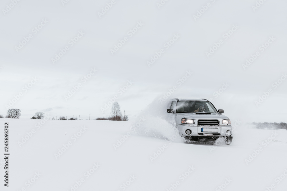 Car driving on snow field