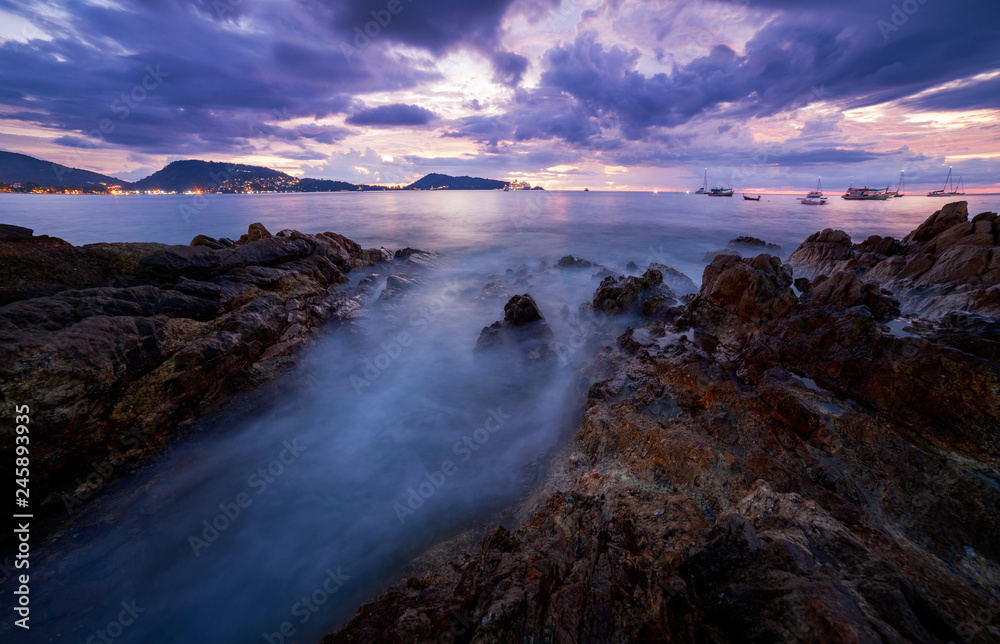 Fototapeta premium Long exposure image of Dramatic sky seascape with rock in sunset scenery, Beautiful Landscape and light of nature in evening with beautiful colors Clouds and sky