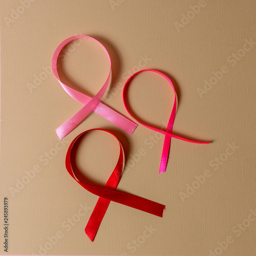 Red and pink ribbon breast cancer awarerness on brown background and copy space for text. photo