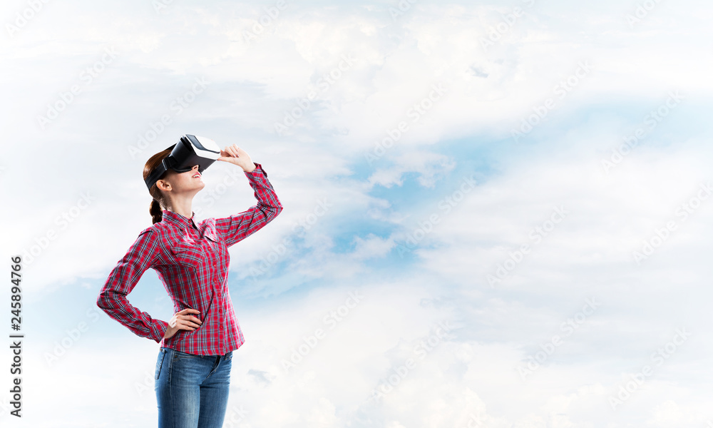 Girl in checked shirt wearing VR glasses experiencing another reality Girl in checked shirt wearing VR glasses experiencing another reality