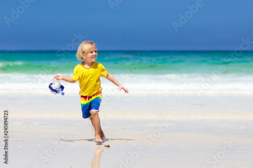 Child snorkeling on tropical beach. Kids snorkel. © famveldman