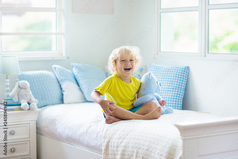 Child playing in bed. Kids room. Baby boy at home. Child playing in bed. Kids room. Baby boy at home.